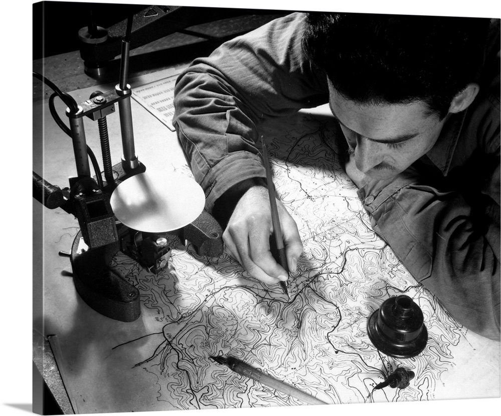 Sergeant inking in the pencil tracings on map, 1943.