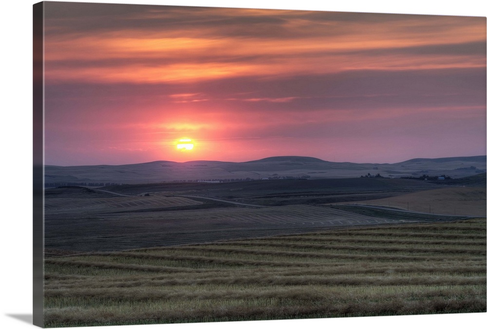 August 31, 2012 - Setting sun over harvested field, Gleichen, Alberta, Canada.