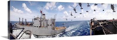 SH60 helicopters transfer ammunition between USS Harry S Truman and USNS Mount Baker