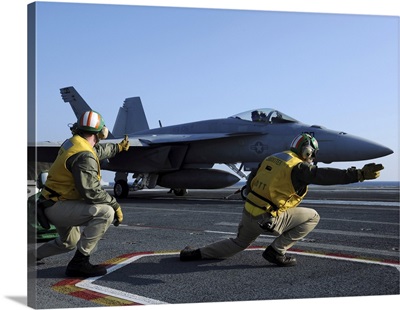 Shooters Aboard The USS George HW Bush Give The Signal To Launch An F/A-18 Super Hornet