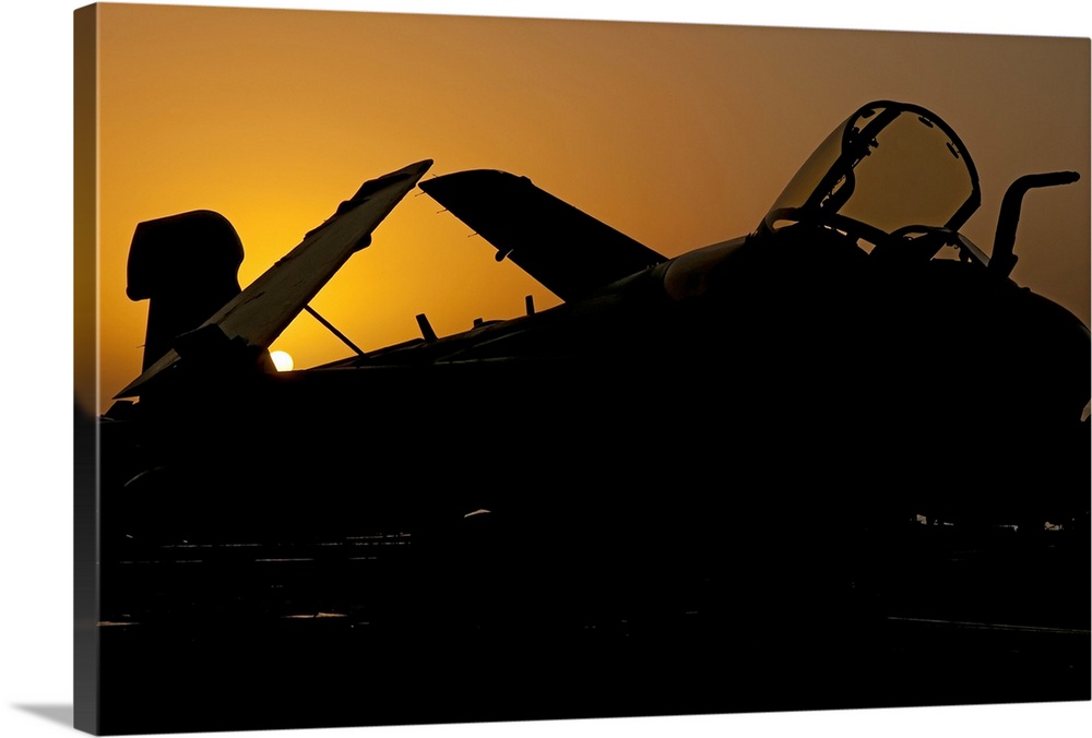 Silhouette of an EA-6B Prowler at sunrise on the flight deck of USS Nimitz during Operation Enduring Freedom. Nimitz is op...