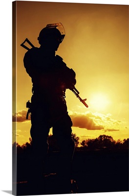 Silhouette Of Police Officer With Weapons At Sunset