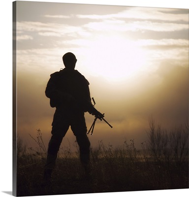 Silhouette Of U.S. Marine With Rifle Against The Sunset