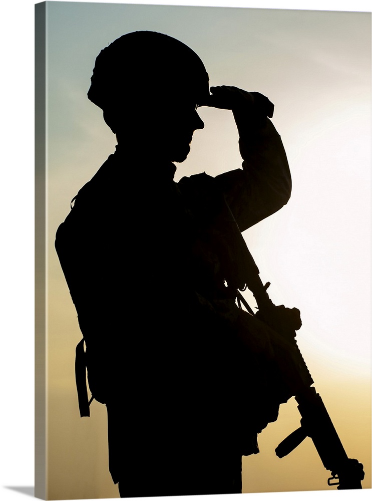 Silhouette of U.S. soldier with rifle against the sunset.