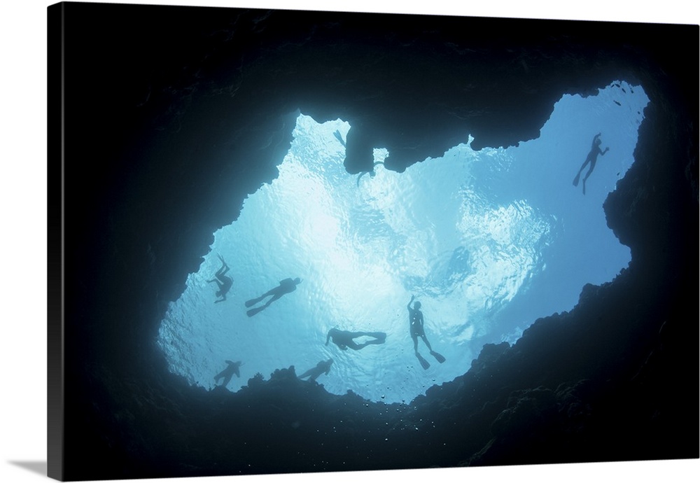 Snorkelers swim above a blue hole on Palau's barrier reef.
