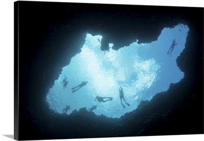 Snorkelers swim above a blue hole on Palau's barrier reef