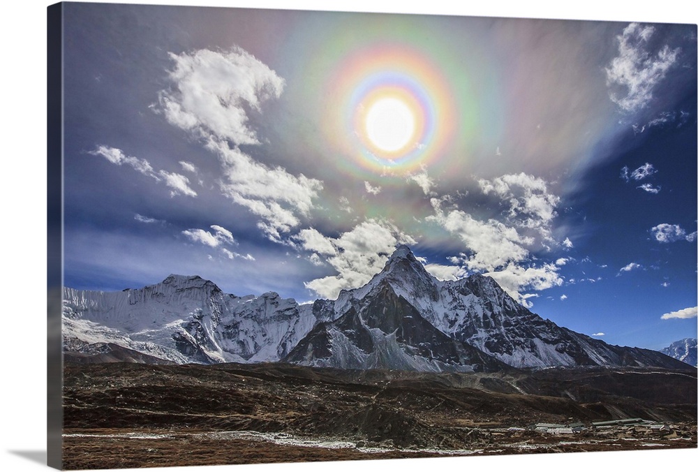 Colorful solar corona over the Himalayas. In the foreground is the famous Himalayan mountain peak Ama Dablam (Mother's Nec...