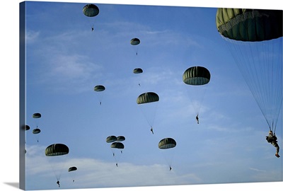 Soldiers descend under a parachute canopy during Operation Toy Drop