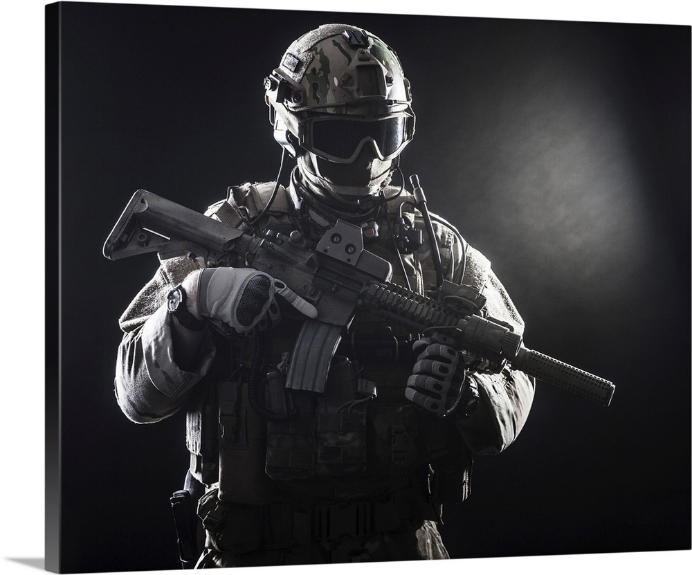 Special forces soldier with rifle on dark background.