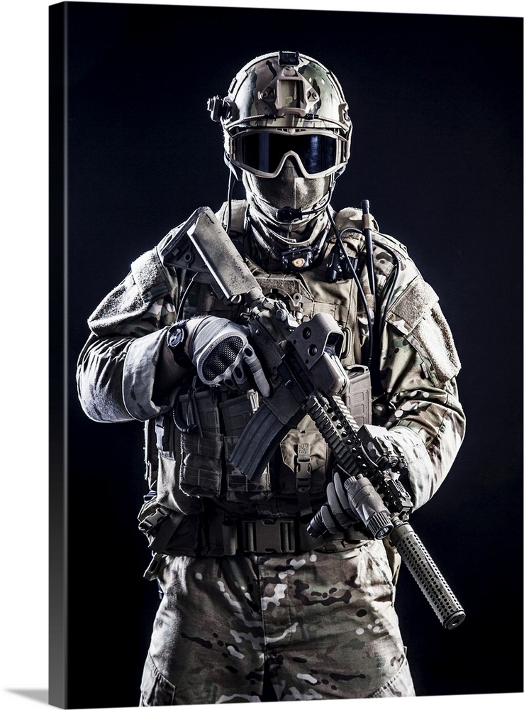 Special forces soldier with rifle on dark background.