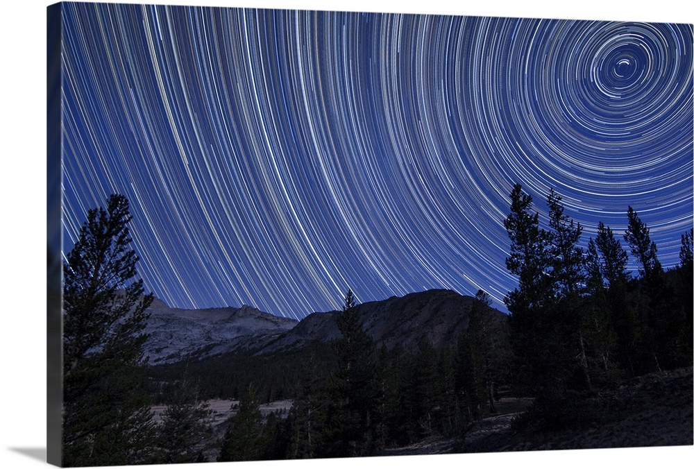 Star trails above mountain peaks in the high sierras near Yosemite National Park, California.