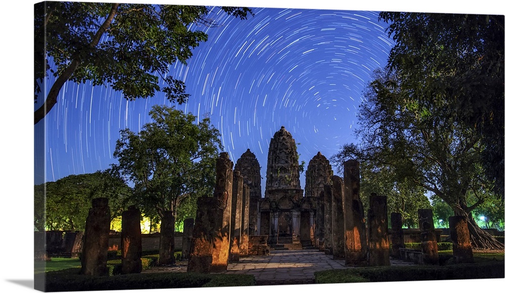 Star trails around the northern celestial pole above a temple in Sukhothai, Thailand.