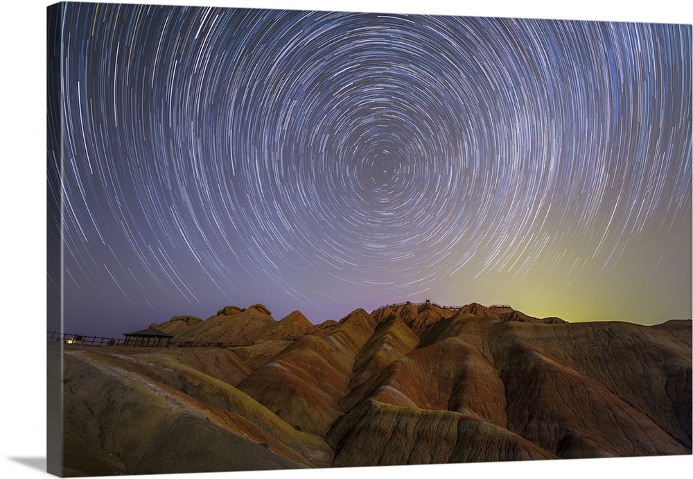 Star trails around the northern celestial pole above the Zhangye Danxia Landform in China.