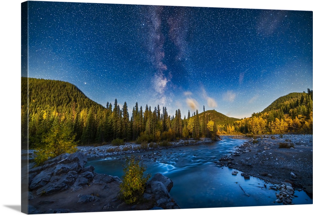 A nightscape scene of the summer Milky Way setting over the Elbow River in southern Alberta, Canada