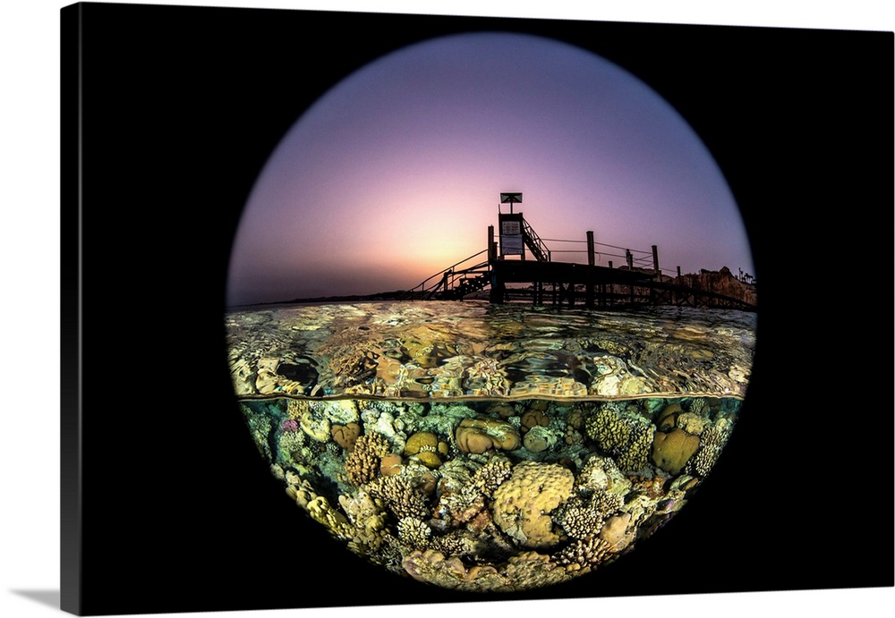 Sunset over the pier and coral gardens at in the Red Sea.