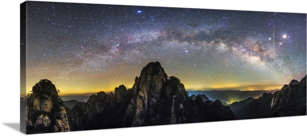The arc of the Milky Way and a bright streaking meteor , Mount Huangshan, China.