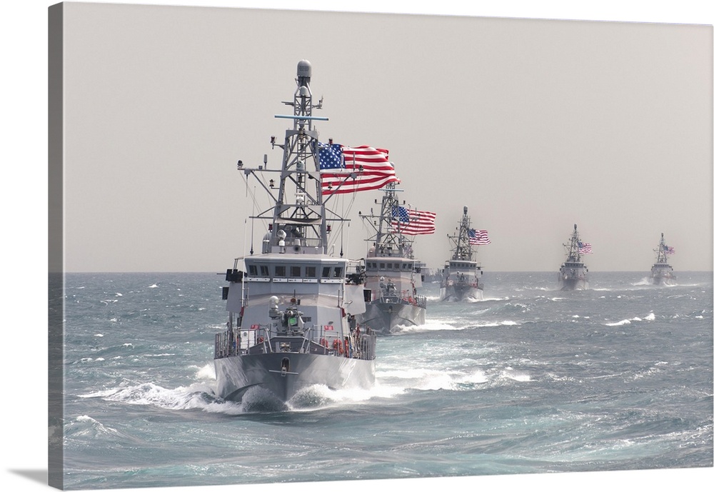 The Cyclone-class coastal patrol ship USS Hurricane leads other ships in formation.