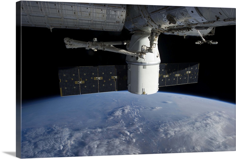 March 3, 2013 - The docking of SpaceX Dragon to the International Space Station above a cloud covered Earth.