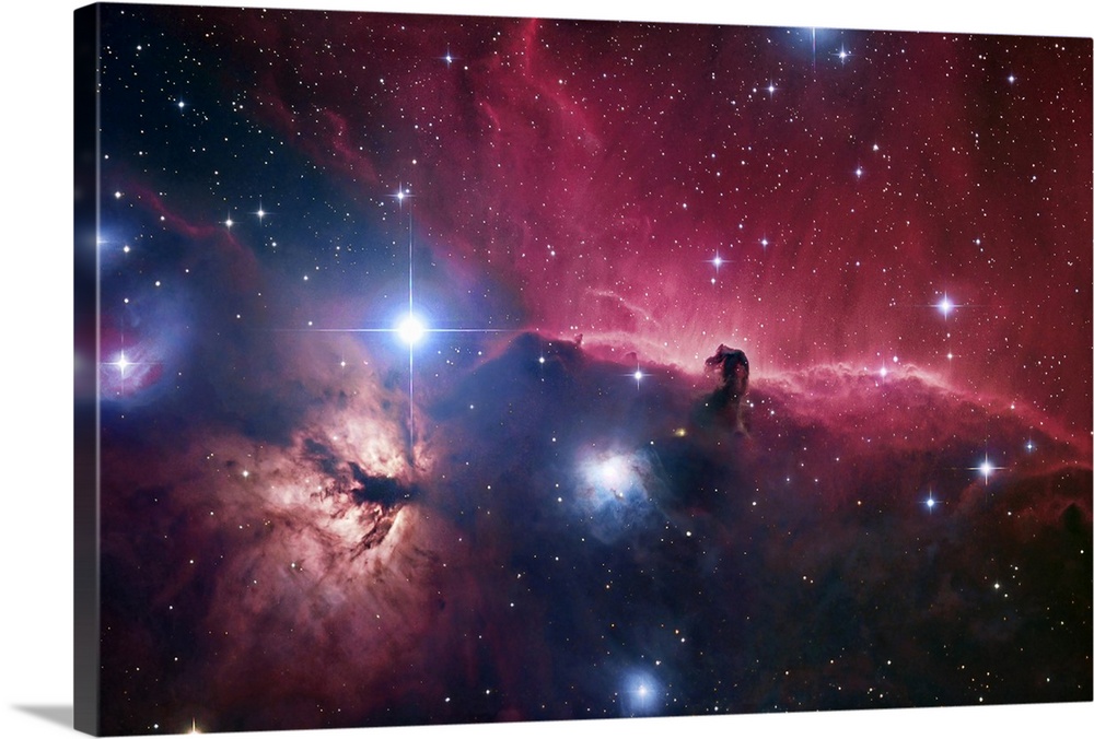 Large photograph displays an open part of space filled with stars and focusing on aodark cloud of gas and dust within the ...