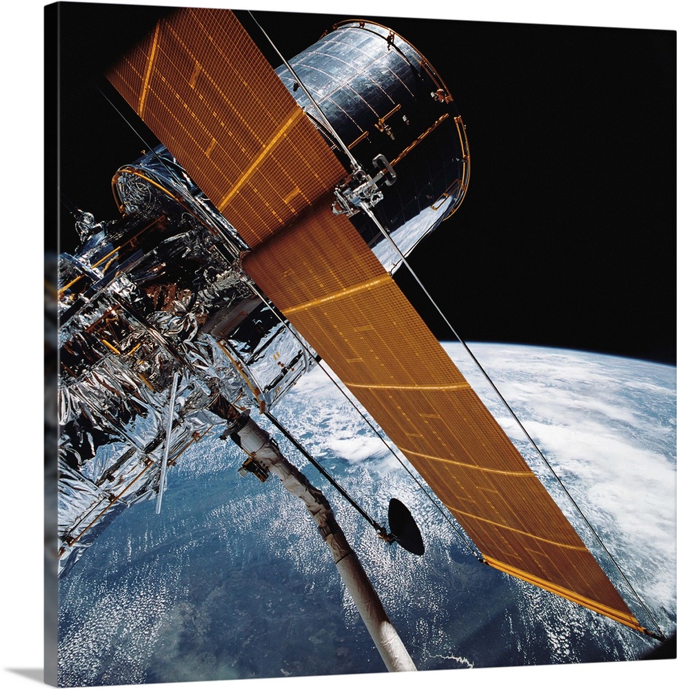 April 25, 1990 - The Hubble Space Telescope backdropped by planet Earth.