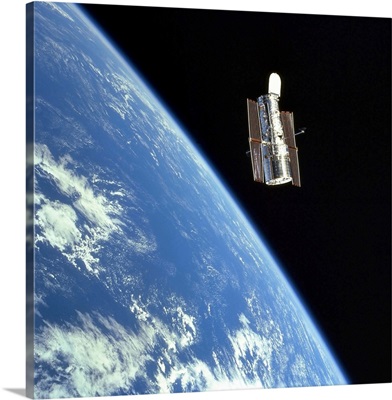 The Hubble Space Telescope with a blue earth in the background