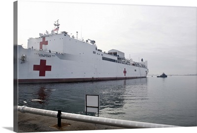 The Military Sealift Command hospital ship USNS Comfort pulls away from Canton Pier