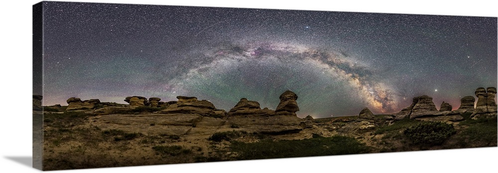 Panorama of the Milky Way arching over Writing-on-Stone Provincia Park in Alberta, Canada.