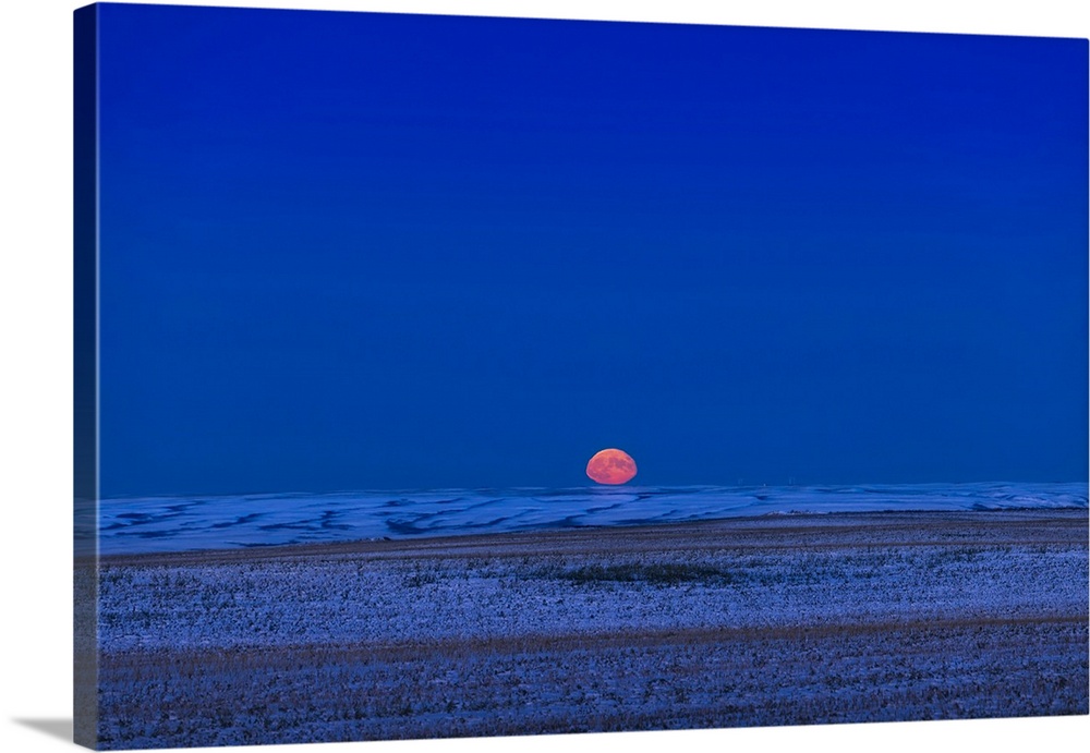 The Moon Rising Over A Prairie Horizon, With Atmospheric Refraction Flattening The Disk