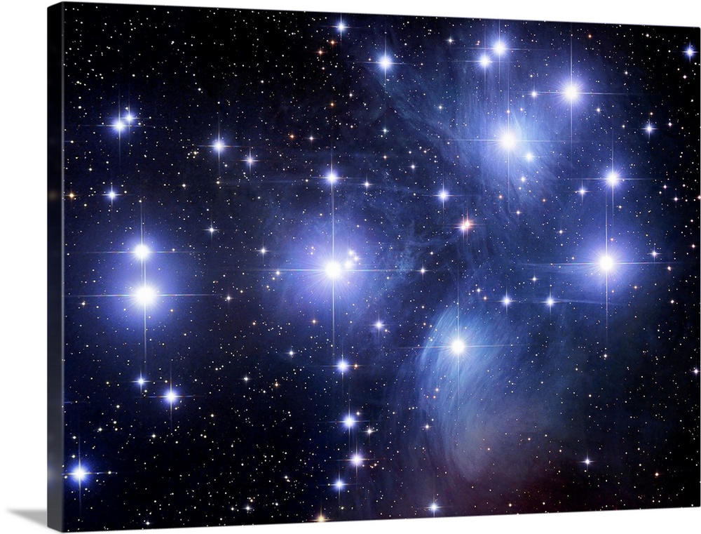 Large photograph taken of the Seven Sisters, an open star cluster located within the constellation of Taurus.  The bright ...