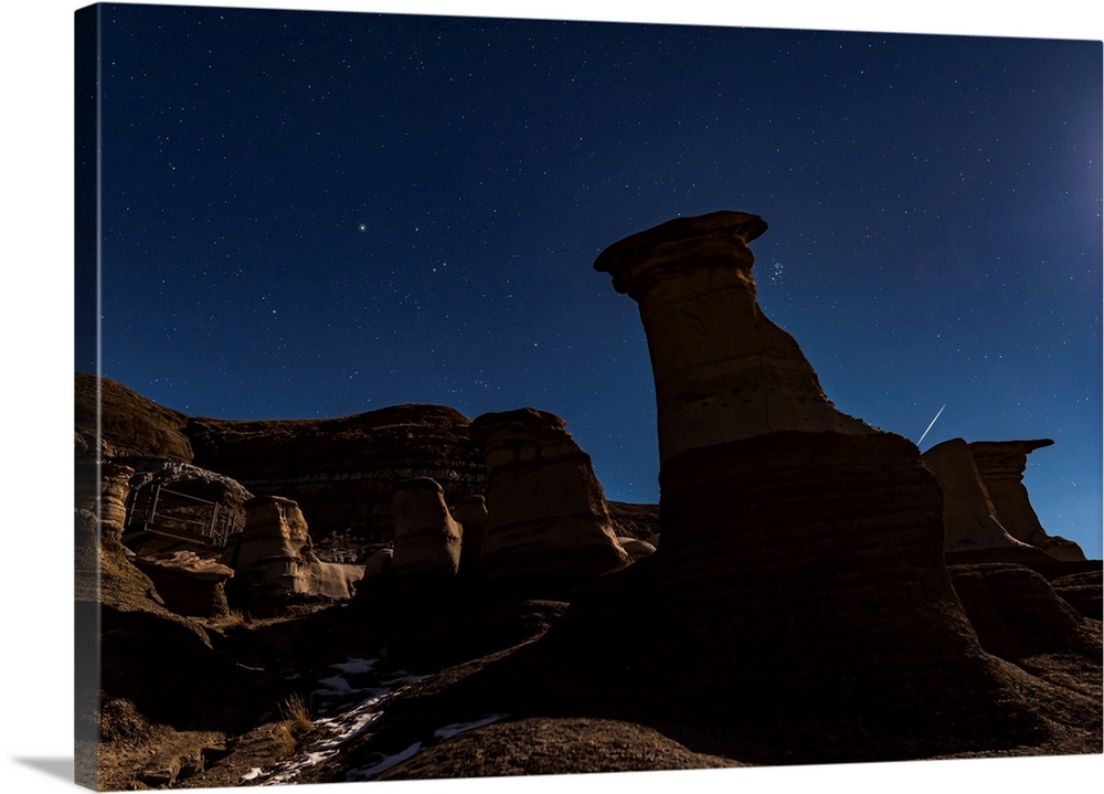 The Pleiades appearing from behind the Hoodoos in silhouette.