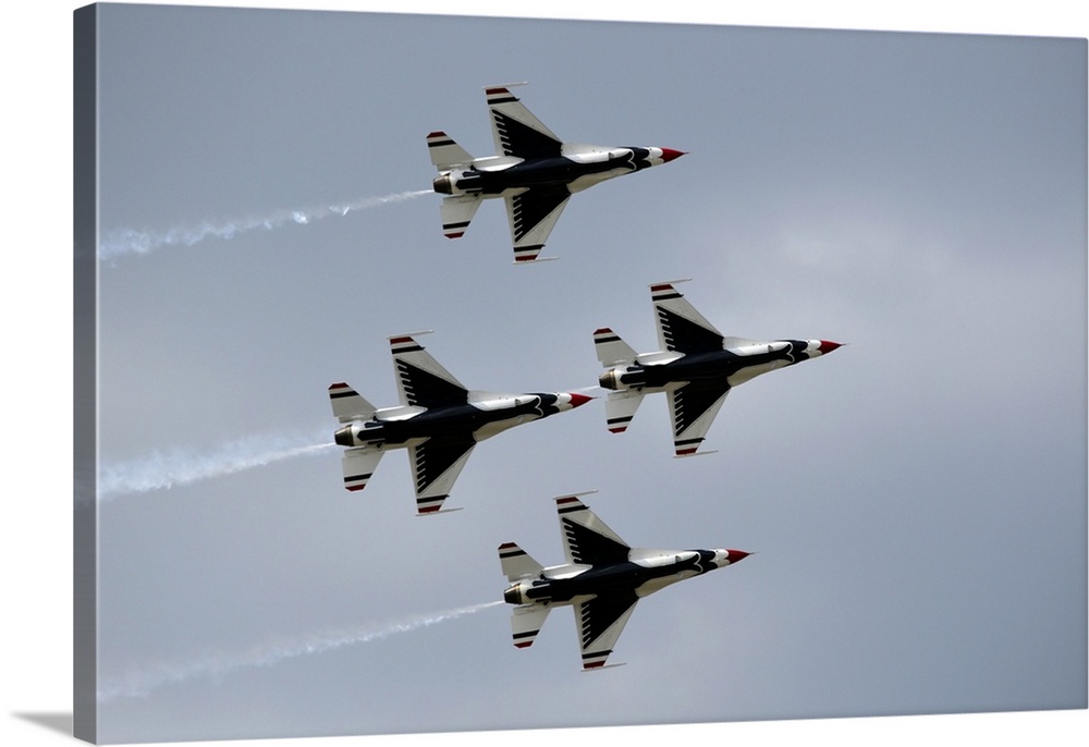 The United States Air Force Thunderbirds demonstration squadron fly in diamond formation over Lakeland, Florida.