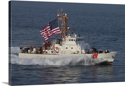 The US Coast Guard Cutter Adak  transits at maximum speed