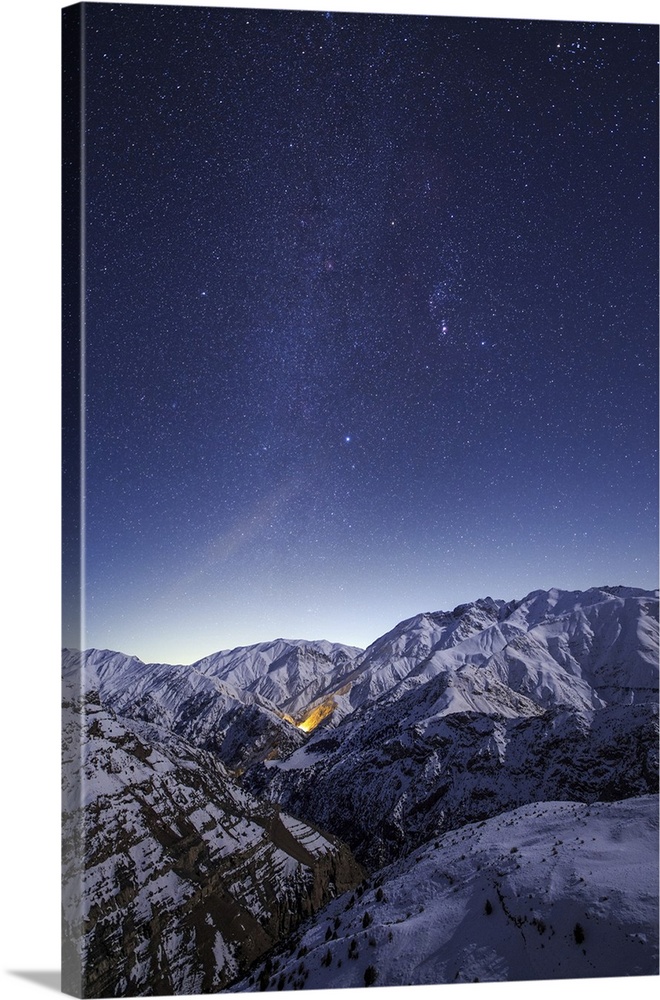 The winter Milky Way shines above the snow-covered  Alborz Mountain Range in Iran.