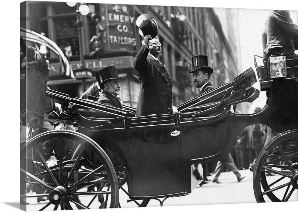 June 23, 1910 - Former President Theodore Roosevelt standing in a horse drawn carriage, tipping his hat to onlookers on Fi...