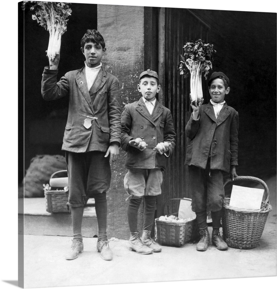 Three boys selling fruits and vegetables on the streets of Boston, Massachusetts in 1909.