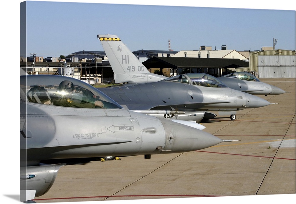 Three F-16 Fighting Falcons prepare to taxi for departure.