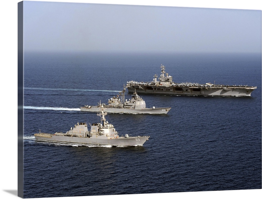 Three U.S. Navy ships sail in formation in the Arabian Sea.