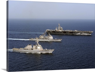 Three US Navy ships sail in formation in the Arabian Sea