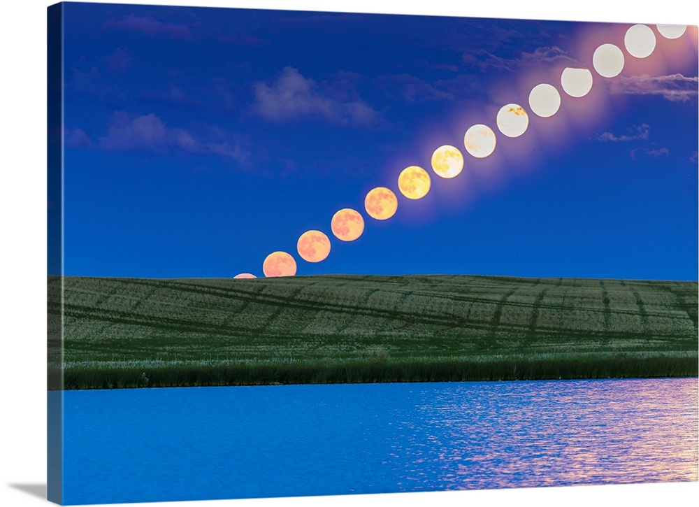 Time lapse of a full moon rising over a prairie pond in Alberta, Canada.