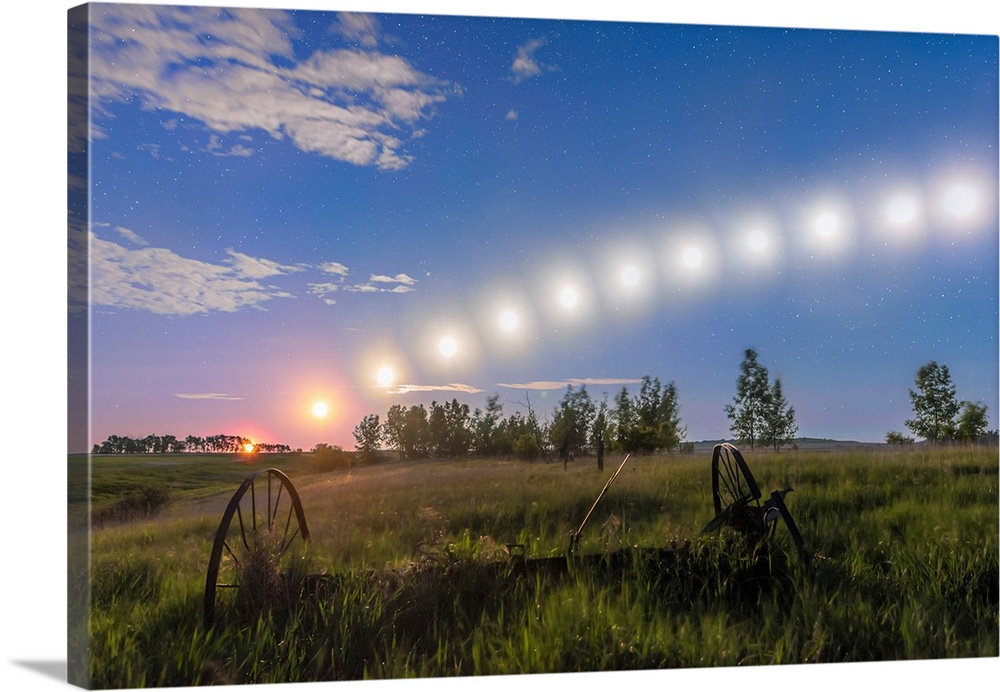 Trail of the waning gibbous moon tracking low across the sky in Alberta, Canada.