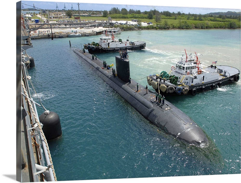 Tugboats assist the Los Angeles-class attack submarine USS Topeka.