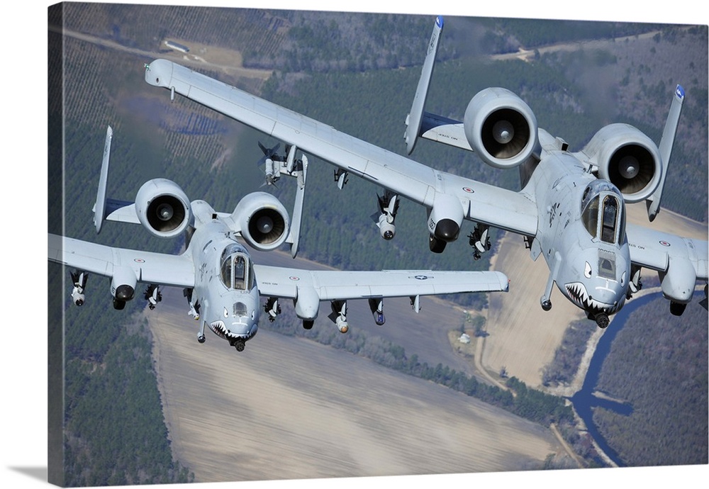 Two A-10C Thunderbolt II aircraft fly in formation.