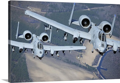 Two A-10C Thunderbolt II aircraft fly in formation