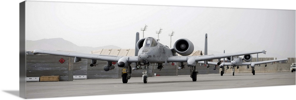 Two A10 Thunderbolts taxi out to the runway