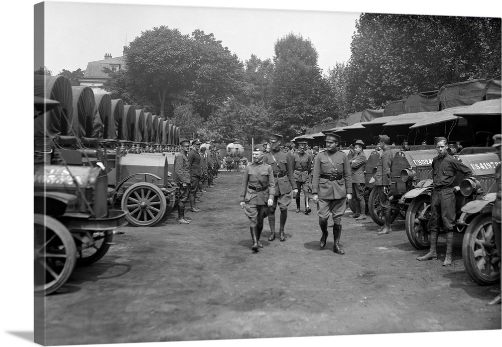 Two American Army officers inspecting a fleet of American Red Cross vehicles during WW1.