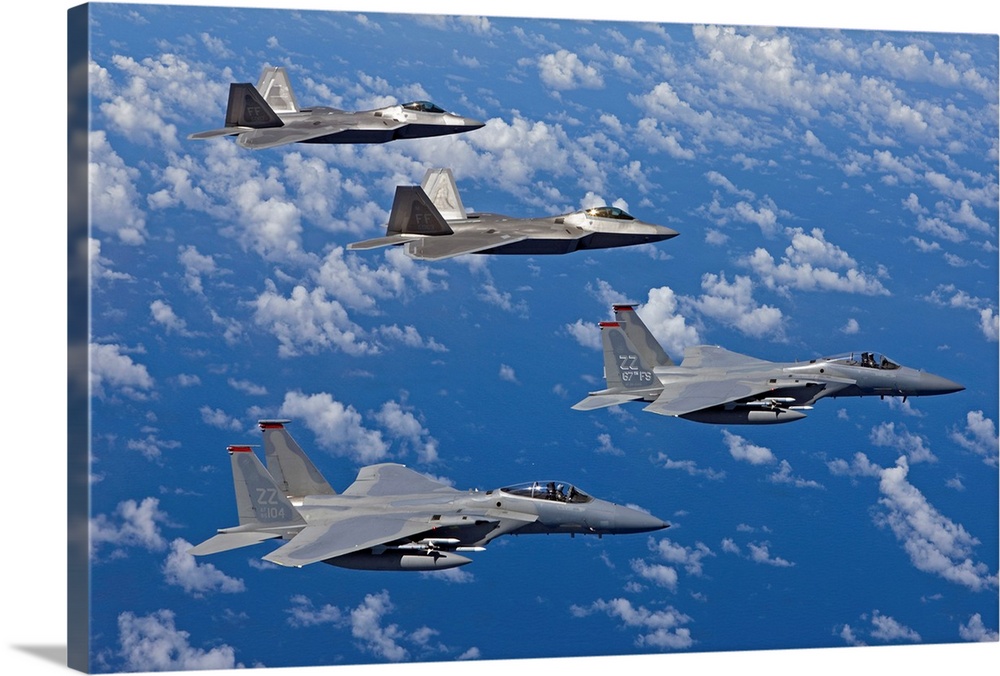 Two F-15 Eagles from the 67th Fighter Squadron in Kadena Air Base, Okinawa, Japan, fly over the Pacific Ocean in formation...