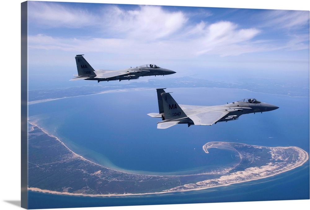 Two F-15 Eagles from the Massachusetts Air National Guard fly high over Cape Cod during a training mission.