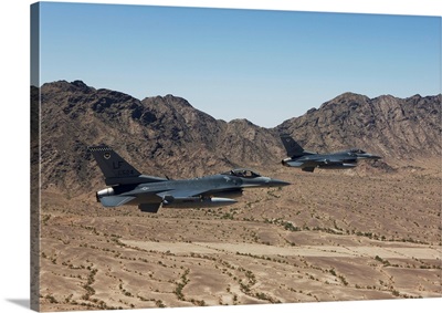 Two F-16s fly in formation over the Arizona desert