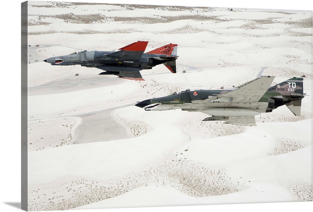 Two QF-4E Phantoms in formation over the White Sands National Monument in New Mexico.