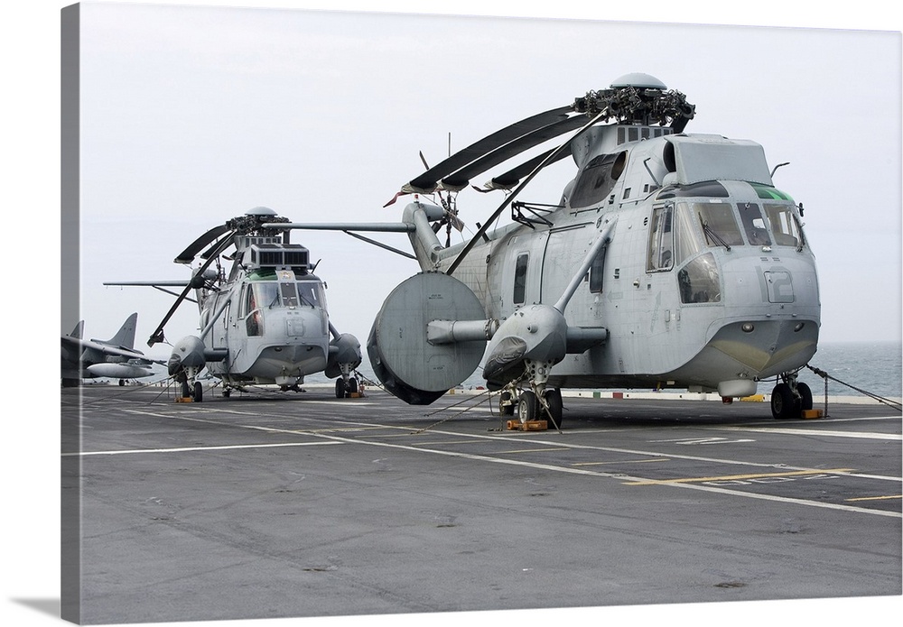Two SH-3H helicopters of the Spanish Navy aboard an aircraft carrier.